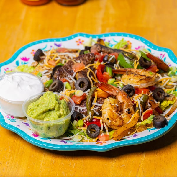 Zapata's fajita salad with grilled shrimp, steak, vegetables, cheese, guacamole, and sour cream.